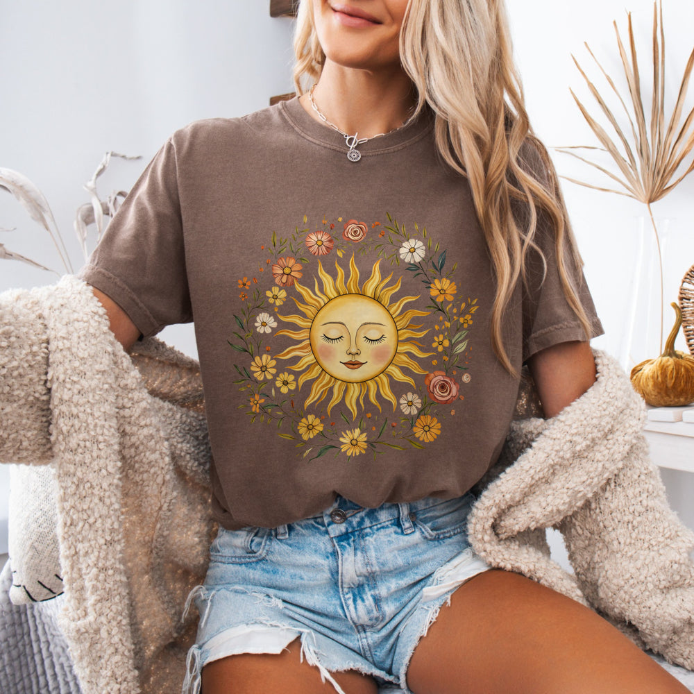 Woman wearing an Espresso Comfort Colors 1717 tee with a vintage sun and floral graphic
