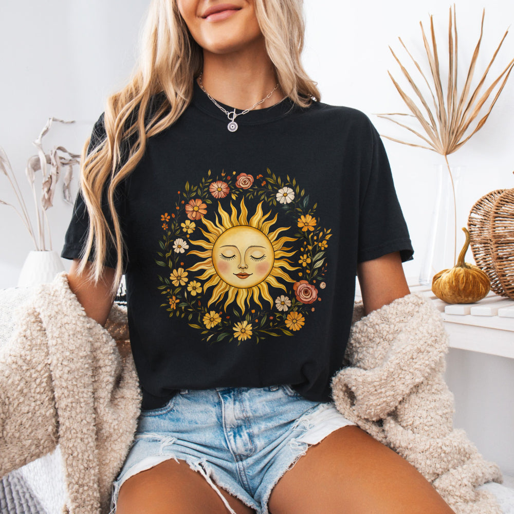 Woman wearing a Black Comfort Colors 1717 tee with a vintage sun and floral graphic
