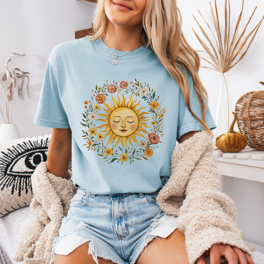 Woman wearing a Chambray Comfort Colors 1717 tee with a vintage sun and floral graphic