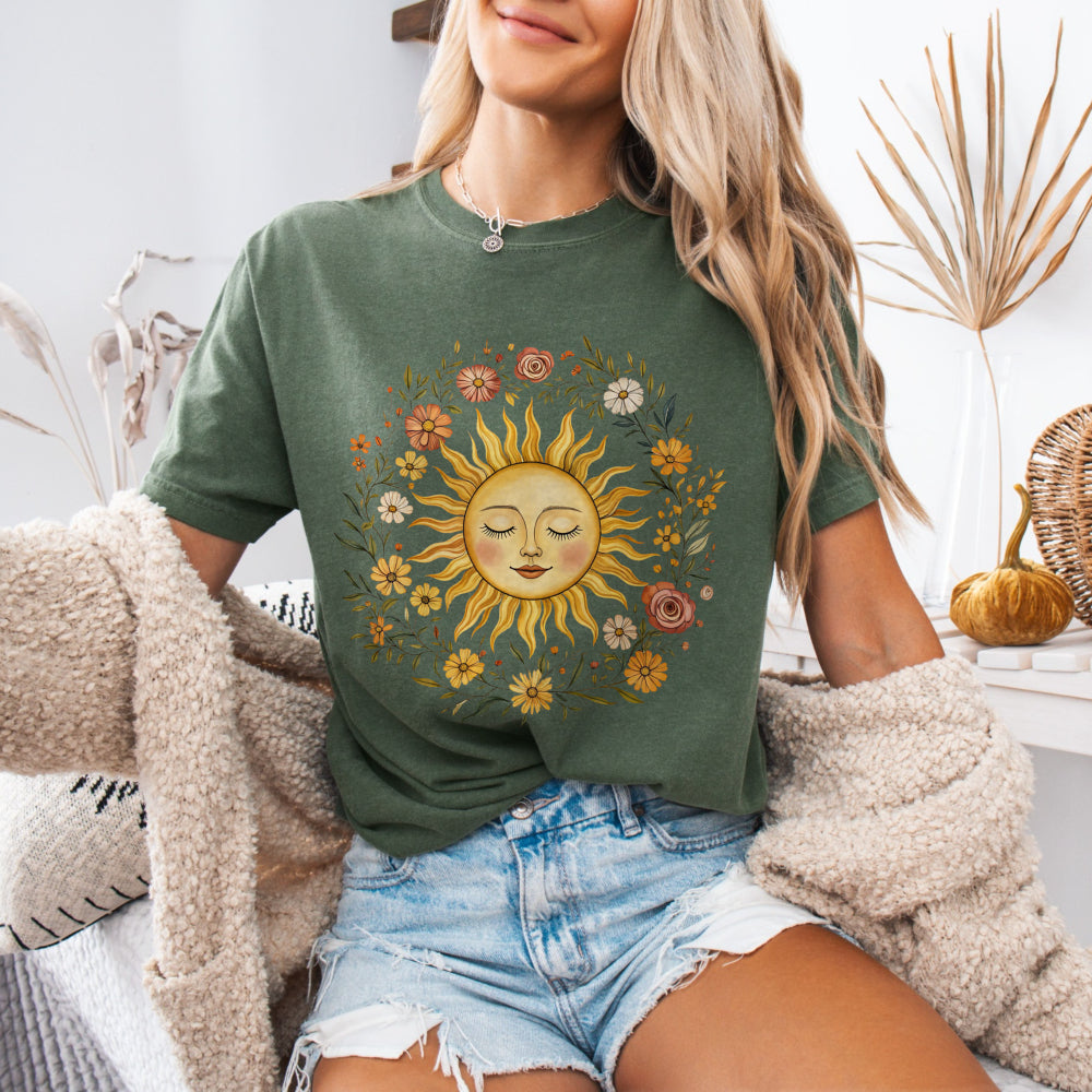Woman wearing a Moss Comfort Colors 1717 tee with a vintage sun and floral graphic