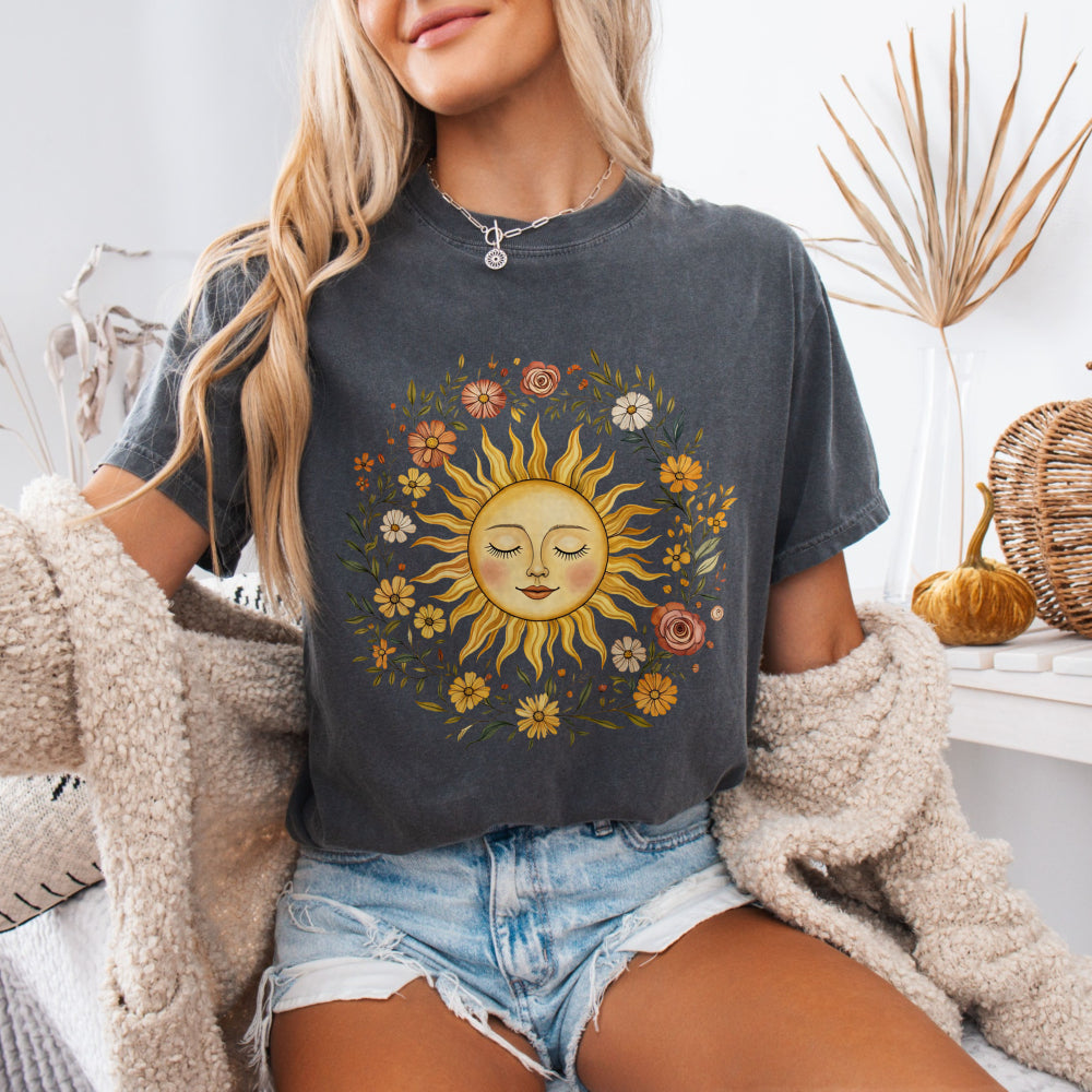 Woman wearing a Pepper Comfort Colors 1717 tee with a vintage sun and floral graphic