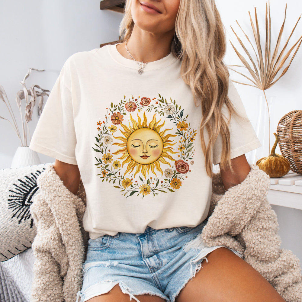 Woman wearing an Ivory Comfort Colors 1717 tee with a vintage sun and floral graphic